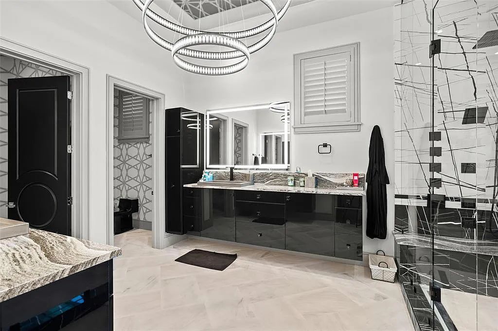 This luxurious lakefront mansion at 9306 Blanche Cove Drive in Windermere, Florida, is a custom-crafted masterpiece built for the ultimate sports enthusiast. The 5-bedroom, 8-bath home spans 14,856 square feet and includes a 6,060 square foot air-conditioned full-sized basketball court, a theater, an exercise room with sauna, and a two-story master closet.