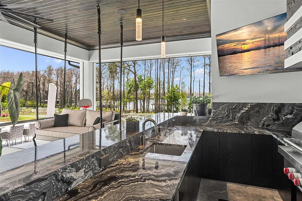 This luxurious lakefront mansion at 9306 Blanche Cove Drive in Windermere, Florida, is a custom-crafted masterpiece built for the ultimate sports enthusiast. The 5-bedroom, 8-bath home spans 14,856 square feet and includes a 6,060 square foot air-conditioned full-sized basketball court, a theater, an exercise room with sauna, and a two-story master closet.