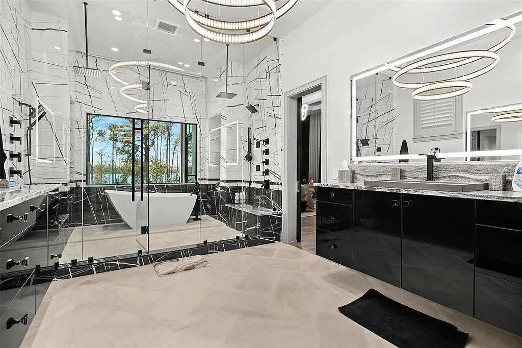 This luxurious lakefront mansion at 9306 Blanche Cove Drive in Windermere, Florida, is a custom-crafted masterpiece built for the ultimate sports enthusiast. The 5-bedroom, 8-bath home spans 14,856 square feet and includes a 6,060 square foot air-conditioned full-sized basketball court, a theater, an exercise room with sauna, and a two-story master closet.