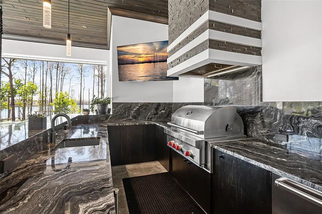 This luxurious lakefront mansion at 9306 Blanche Cove Drive in Windermere, Florida, is a custom-crafted masterpiece built for the ultimate sports enthusiast. The 5-bedroom, 8-bath home spans 14,856 square feet and includes a 6,060 square foot air-conditioned full-sized basketball court, a theater, an exercise room with sauna, and a two-story master closet.