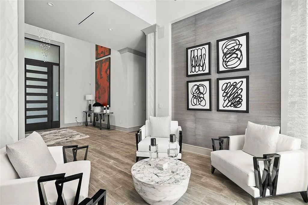 This luxurious lakefront mansion at 9306 Blanche Cove Drive in Windermere, Florida, is a custom-crafted masterpiece built for the ultimate sports enthusiast. The 5-bedroom, 8-bath home spans 14,856 square feet and includes a 6,060 square foot air-conditioned full-sized basketball court, a theater, an exercise room with sauna, and a two-story master closet.
