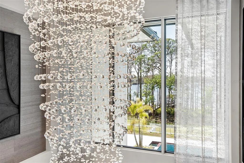 This luxurious lakefront mansion at 9306 Blanche Cove Drive in Windermere, Florida, is a custom-crafted masterpiece built for the ultimate sports enthusiast. The 5-bedroom, 8-bath home spans 14,856 square feet and includes a 6,060 square foot air-conditioned full-sized basketball court, a theater, an exercise room with sauna, and a two-story master closet.