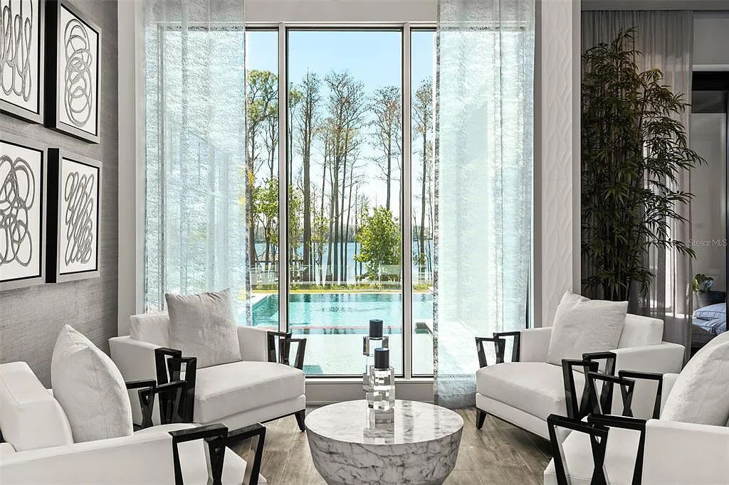 This luxurious lakefront mansion at 9306 Blanche Cove Drive in Windermere, Florida, is a custom-crafted masterpiece built for the ultimate sports enthusiast. The 5-bedroom, 8-bath home spans 14,856 square feet and includes a 6,060 square foot air-conditioned full-sized basketball court, a theater, an exercise room with sauna, and a two-story master closet.