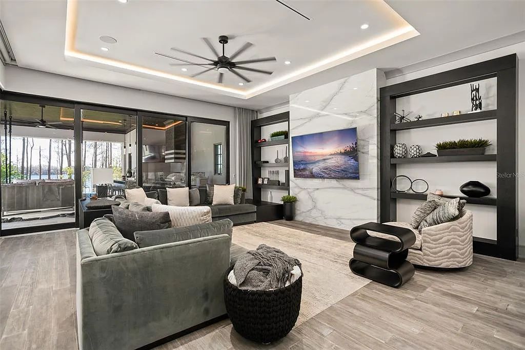 This luxurious lakefront mansion at 9306 Blanche Cove Drive in Windermere, Florida, is a custom-crafted masterpiece built for the ultimate sports enthusiast. The 5-bedroom, 8-bath home spans 14,856 square feet and includes a 6,060 square foot air-conditioned full-sized basketball court, a theater, an exercise room with sauna, and a two-story master closet.