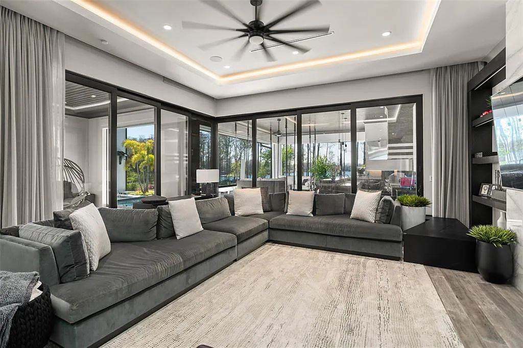 This luxurious lakefront mansion at 9306 Blanche Cove Drive in Windermere, Florida, is a custom-crafted masterpiece built for the ultimate sports enthusiast. The 5-bedroom, 8-bath home spans 14,856 square feet and includes a 6,060 square foot air-conditioned full-sized basketball court, a theater, an exercise room with sauna, and a two-story master closet.
