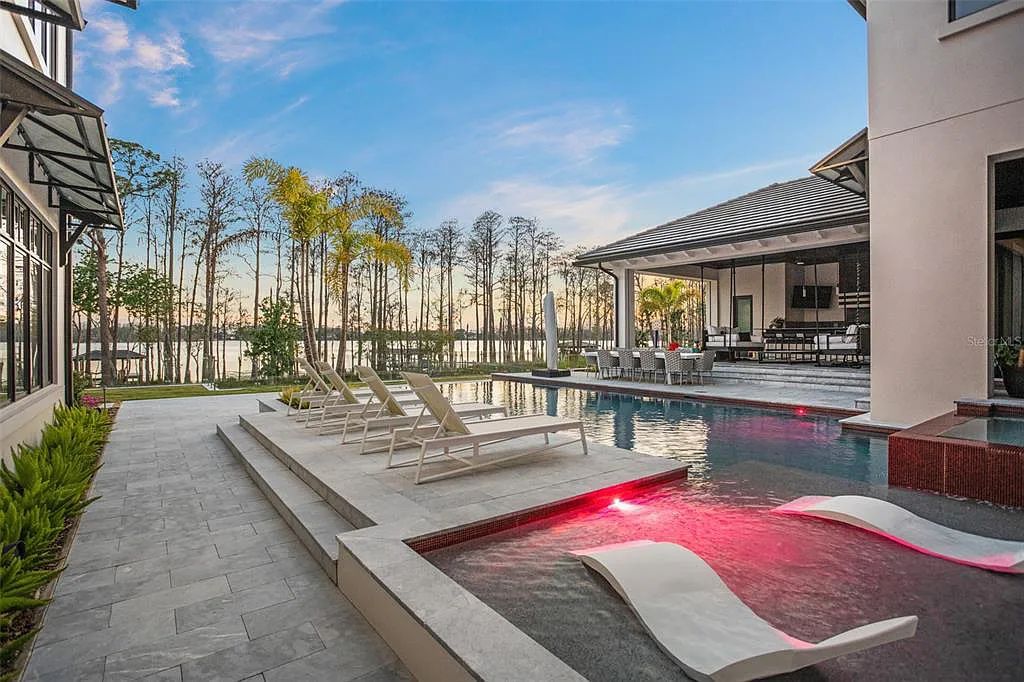 This luxurious lakefront mansion at 9306 Blanche Cove Drive in Windermere, Florida, is a custom-crafted masterpiece built for the ultimate sports enthusiast. The 5-bedroom, 8-bath home spans 14,856 square feet and includes a 6,060 square foot air-conditioned full-sized basketball court, a theater, an exercise room with sauna, and a two-story master closet.