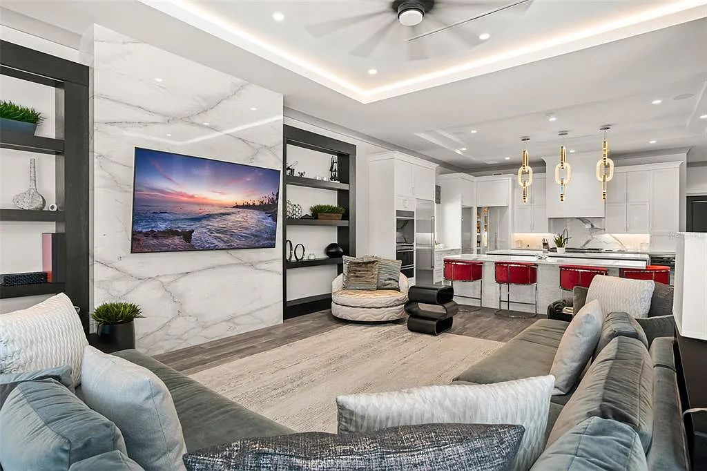This luxurious lakefront mansion at 9306 Blanche Cove Drive in Windermere, Florida, is a custom-crafted masterpiece built for the ultimate sports enthusiast. The 5-bedroom, 8-bath home spans 14,856 square feet and includes a 6,060 square foot air-conditioned full-sized basketball court, a theater, an exercise room with sauna, and a two-story master closet.