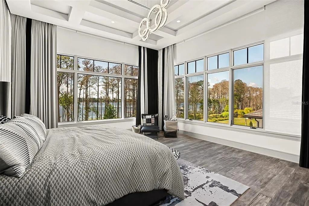 This luxurious lakefront mansion at 9306 Blanche Cove Drive in Windermere, Florida, is a custom-crafted masterpiece built for the ultimate sports enthusiast. The 5-bedroom, 8-bath home spans 14,856 square feet and includes a 6,060 square foot air-conditioned full-sized basketball court, a theater, an exercise room with sauna, and a two-story master closet.