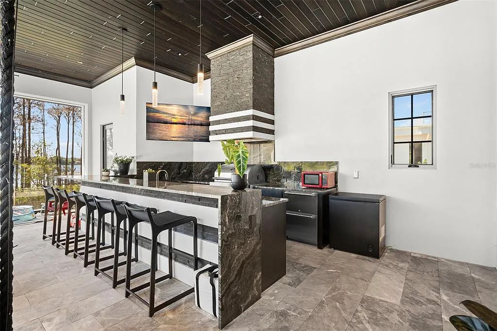 This luxurious lakefront mansion at 9306 Blanche Cove Drive in Windermere, Florida, is a custom-crafted masterpiece built for the ultimate sports enthusiast. The 5-bedroom, 8-bath home spans 14,856 square feet and includes a 6,060 square foot air-conditioned full-sized basketball court, a theater, an exercise room with sauna, and a two-story master closet.