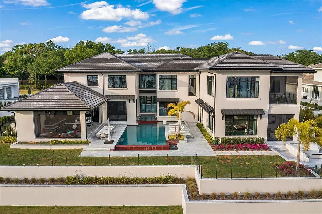 This luxurious lakefront mansion at 9306 Blanche Cove Drive in Windermere, Florida, is a custom-crafted masterpiece built for the ultimate sports enthusiast. The 5-bedroom, 8-bath home spans 14,856 square feet and includes a 6,060 square foot air-conditioned full-sized basketball court, a theater, an exercise room with sauna, and a two-story master closet.