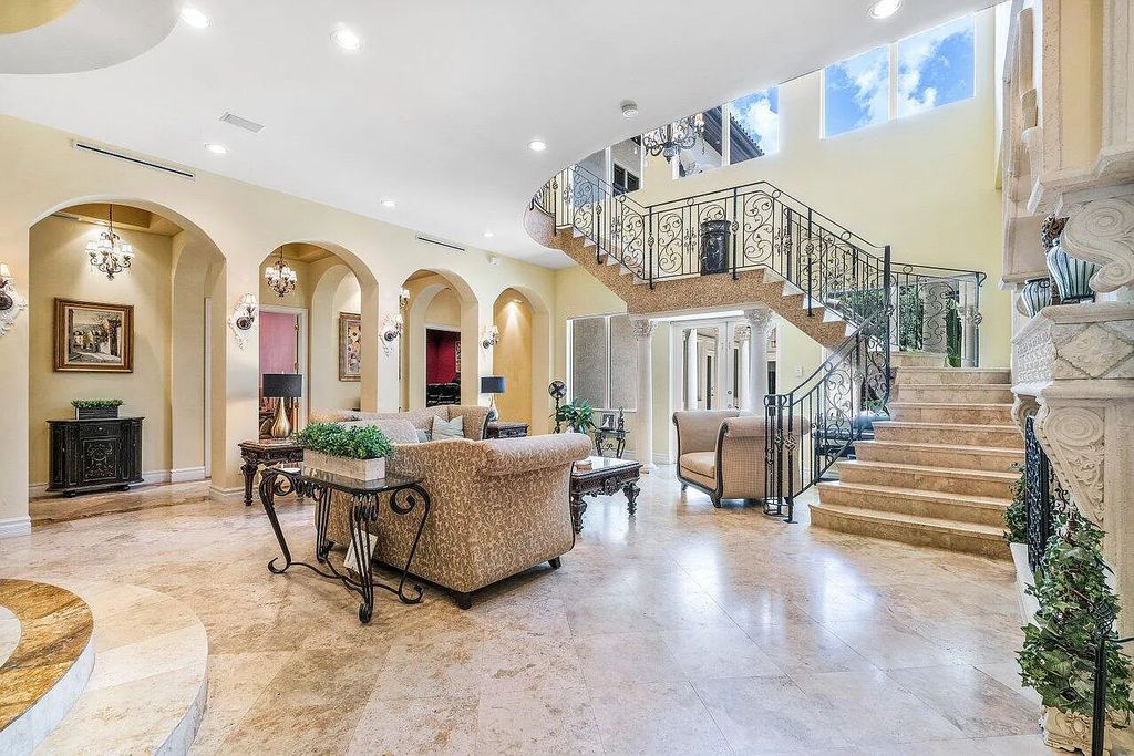 Introducing a stunning house at 14 E Ocean Avenue, located in the highly sought-after area of Boynton Beach, Florida. This luxurious property boasts 6 spacious bedrooms and 7 modern bathrooms, perfect for accommodating large families or hosting guests.