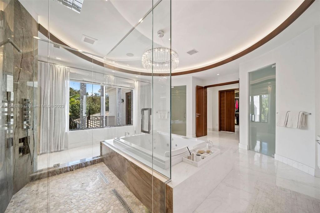 Welcome to 8955 SW 63rd Court in Pinecrest, Florida - an opulent oasis in the sought-after Stritter Estates community. This stunning 6-bedroom, 10-bathroom home boasts over 7,700 square feet of luxurious living space, situated on a sprawling 0.87-acre lot. Built in 2013, this home in Pinecrest is as functional as it is beautiful.
