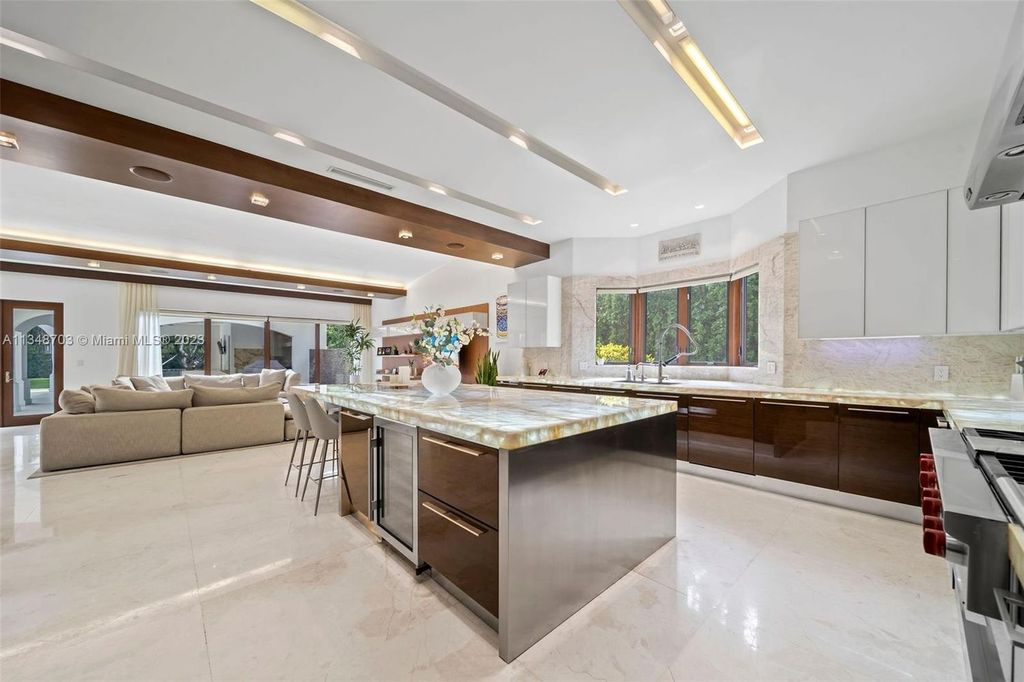 Welcome to 8955 SW 63rd Court in Pinecrest, Florida - an opulent oasis in the sought-after Stritter Estates community. This stunning 6-bedroom, 10-bathroom home boasts over 7,700 square feet of luxurious living space, situated on a sprawling 0.87-acre lot. Built in 2013, this home in Pinecrest is as functional as it is beautiful.