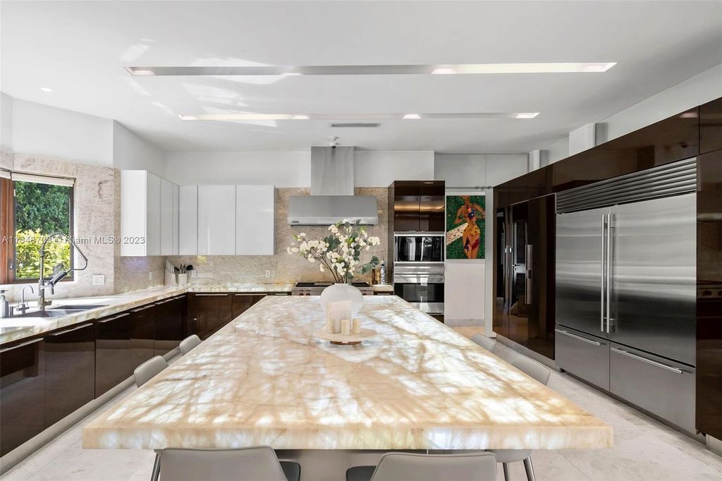 Welcome to 8955 SW 63rd Court in Pinecrest, Florida - an opulent oasis in the sought-after Stritter Estates community. This stunning 6-bedroom, 10-bathroom home boasts over 7,700 square feet of luxurious living space, situated on a sprawling 0.87-acre lot. Built in 2013, this home in Pinecrest is as functional as it is beautiful.