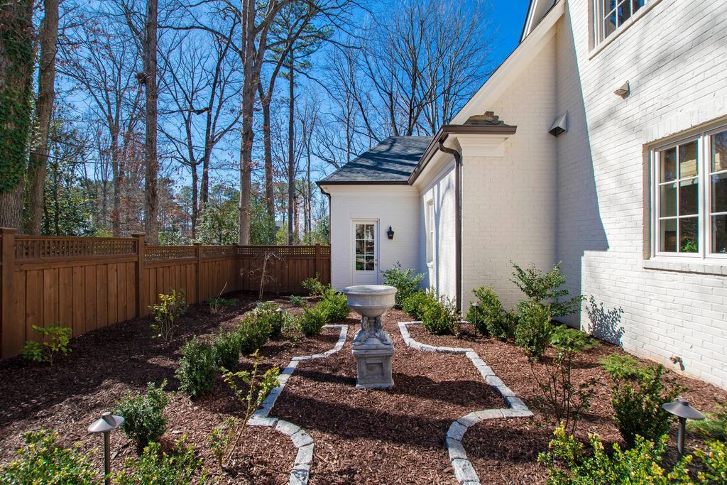 The House in Raleigh has large, beautifully landscaped back yard includes privacy fence, slate patio, and wood-burning fireplace with sitting area, now available for sale. This home located at 3910 Stratford Ct, Raleigh, North Carolina