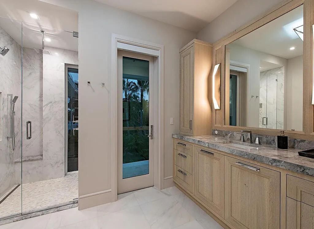 This stunning house located at 2060 Gordon Drive, Naples, Florida, is now available for sale. The newly completed residence is part of a unique, gated beachfront enclave consisting of nine homes, making it a highly coveted property.