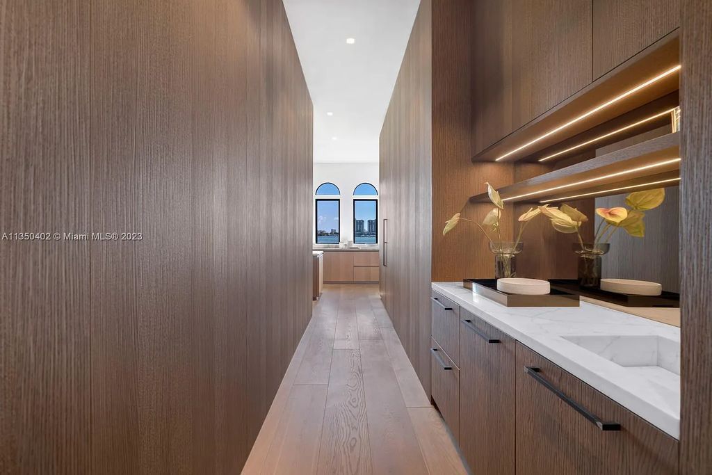 Welcome to 815 E Dilido Drive, Miami Beach, Florida, a stunning transitional home designed by Menin Design. This hme in Miami Beach boasts 6 bedrooms and 8 bathrooms, with a living space of 8,181 square feet, all situated on a spacious 0.31-acre lot. Built in 2006, this home is one of the most impressive properties on the Venetian, offering 107 feet of waterfront living.