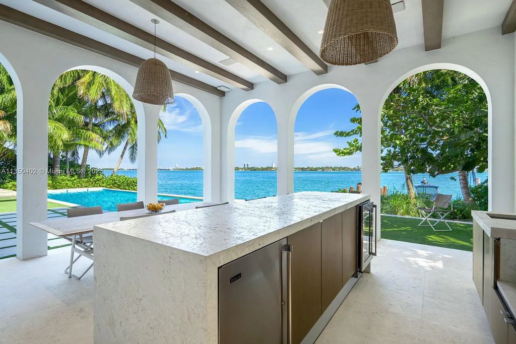 Welcome to 815 E Dilido Drive, Miami Beach, Florida, a stunning transitional home designed by Menin Design. This hme in Miami Beach boasts 6 bedrooms and 8 bathrooms, with a living space of 8,181 square feet, all situated on a spacious 0.31-acre lot. Built in 2006, this home is one of the most impressive properties on the Venetian, offering 107 feet of waterfront living.