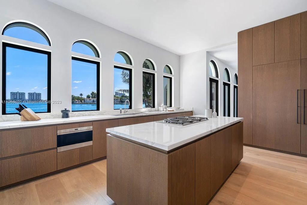 Welcome to 815 E Dilido Drive, Miami Beach, Florida, a stunning transitional home designed by Menin Design. This hme in Miami Beach boasts 6 bedrooms and 8 bathrooms, with a living space of 8,181 square feet, all situated on a spacious 0.31-acre lot. Built in 2006, this home is one of the most impressive properties on the Venetian, offering 107 feet of waterfront living.