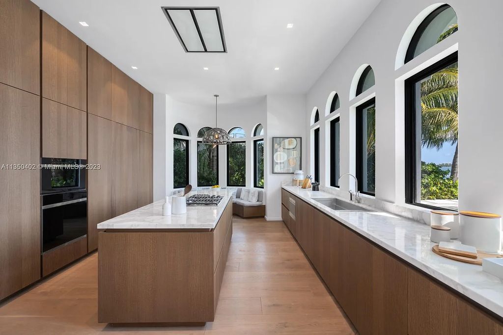 Welcome to 815 E Dilido Drive, Miami Beach, Florida, a stunning transitional home designed by Menin Design. This hme in Miami Beach boasts 6 bedrooms and 8 bathrooms, with a living space of 8,181 square feet, all situated on a spacious 0.31-acre lot. Built in 2006, this home is one of the most impressive properties on the Venetian, offering 107 feet of waterfront living.