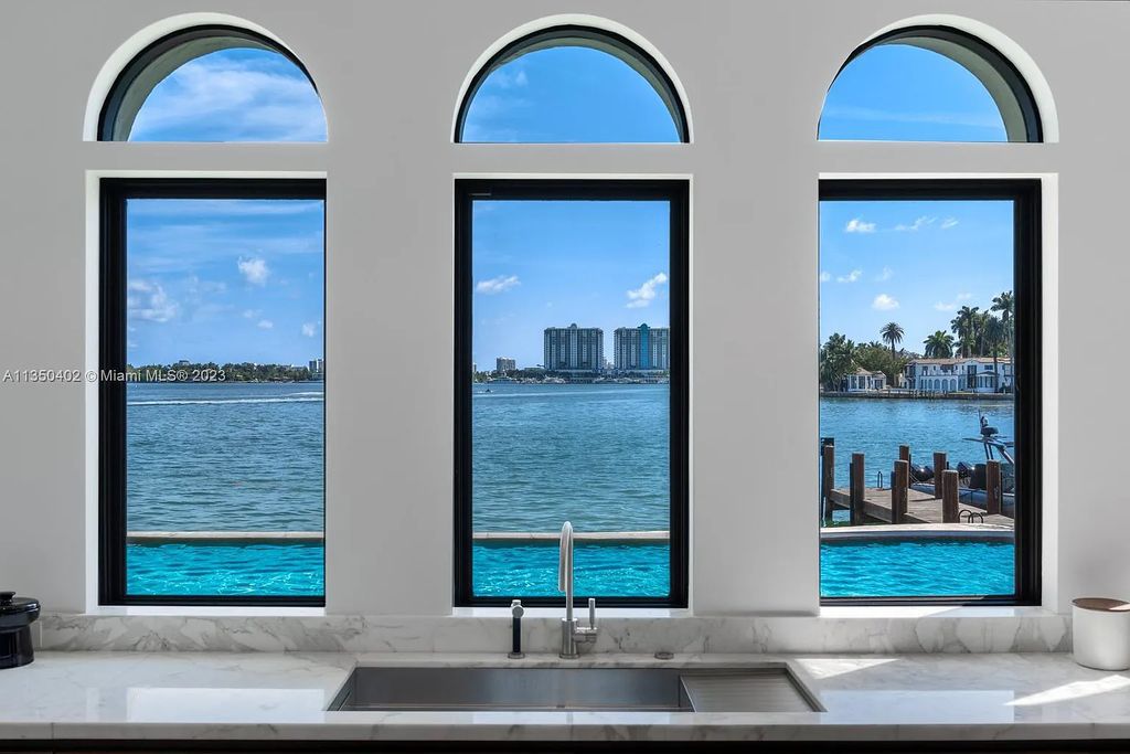 Welcome to 815 E Dilido Drive, Miami Beach, Florida, a stunning transitional home designed by Menin Design. This hme in Miami Beach boasts 6 bedrooms and 8 bathrooms, with a living space of 8,181 square feet, all situated on a spacious 0.31-acre lot. Built in 2006, this home is one of the most impressive properties on the Venetian, offering 107 feet of waterfront living.