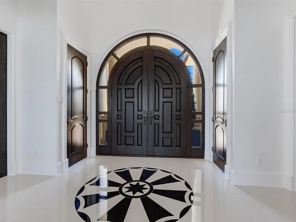 This stunning 2018-built gulf front estate is located at 3909 Casey Key Road in Nokomis, Florida. Boasting 4 bedrooms, 6 bathrooms, and a sprawling living space of 6,335 square feet on a 0.53-acre lot, this refined and elegant home offers breathtaking views of the Gulf of Mexico from the expansive walls of glass.