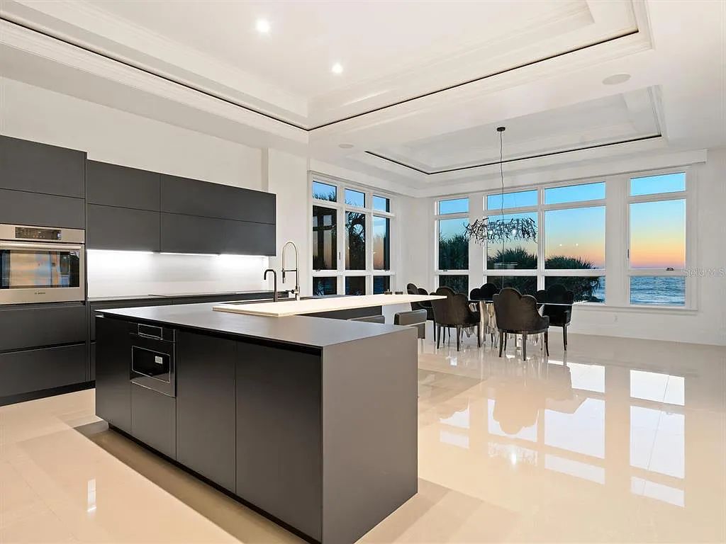 This stunning 2018-built gulf front estate is located at 3909 Casey Key Road in Nokomis, Florida. Boasting 4 bedrooms, 6 bathrooms, and a sprawling living space of 6,335 square feet on a 0.53-acre lot, this refined and elegant home offers breathtaking views of the Gulf of Mexico from the expansive walls of glass.