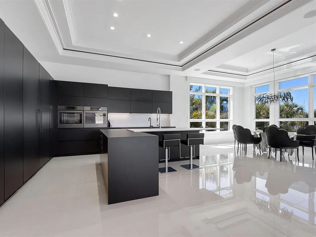 This stunning 2018-built gulf front estate is located at 3909 Casey Key Road in Nokomis, Florida. Boasting 4 bedrooms, 6 bathrooms, and a sprawling living space of 6,335 square feet on a 0.53-acre lot, this refined and elegant home offers breathtaking views of the Gulf of Mexico from the expansive walls of glass.