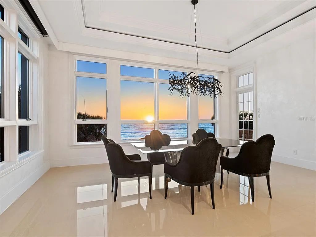 This stunning 2018-built gulf front estate is located at 3909 Casey Key Road in Nokomis, Florida. Boasting 4 bedrooms, 6 bathrooms, and a sprawling living space of 6,335 square feet on a 0.53-acre lot, this refined and elegant home offers breathtaking views of the Gulf of Mexico from the expansive walls of glass.