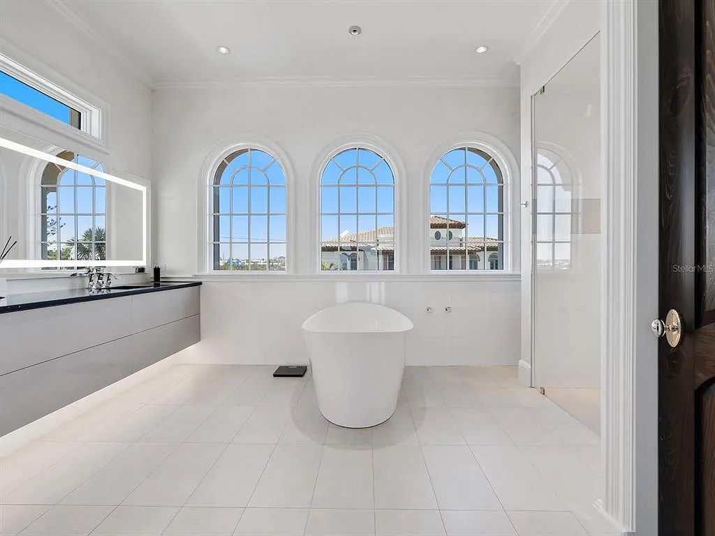 This stunning 2018-built gulf front estate is located at 3909 Casey Key Road in Nokomis, Florida. Boasting 4 bedrooms, 6 bathrooms, and a sprawling living space of 6,335 square feet on a 0.53-acre lot, this refined and elegant home offers breathtaking views of the Gulf of Mexico from the expansive walls of glass.