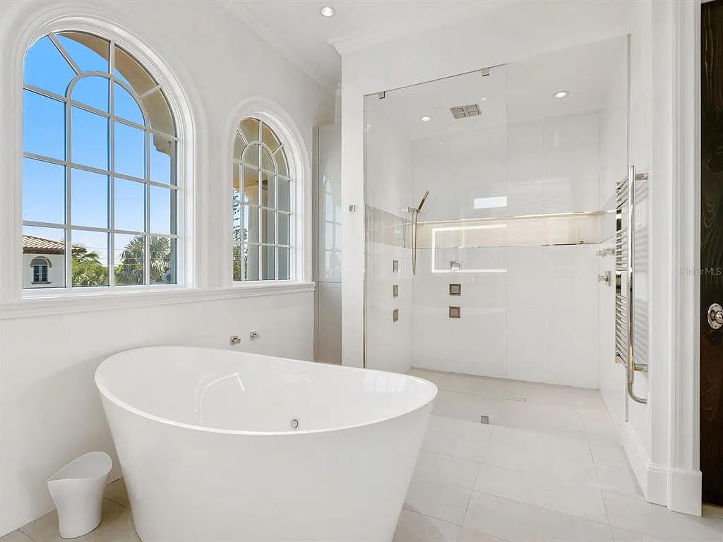 This stunning 2018-built gulf front estate is located at 3909 Casey Key Road in Nokomis, Florida. Boasting 4 bedrooms, 6 bathrooms, and a sprawling living space of 6,335 square feet on a 0.53-acre lot, this refined and elegant home offers breathtaking views of the Gulf of Mexico from the expansive walls of glass.