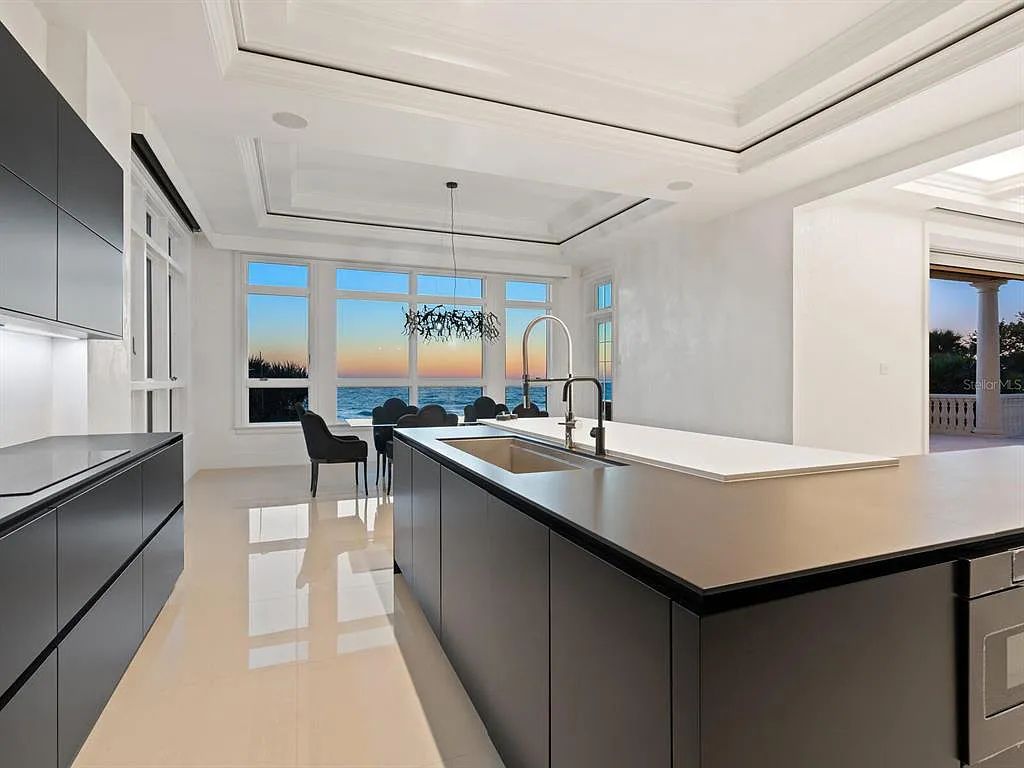 This stunning 2018-built gulf front estate is located at 3909 Casey Key Road in Nokomis, Florida. Boasting 4 bedrooms, 6 bathrooms, and a sprawling living space of 6,335 square feet on a 0.53-acre lot, this refined and elegant home offers breathtaking views of the Gulf of Mexico from the expansive walls of glass.