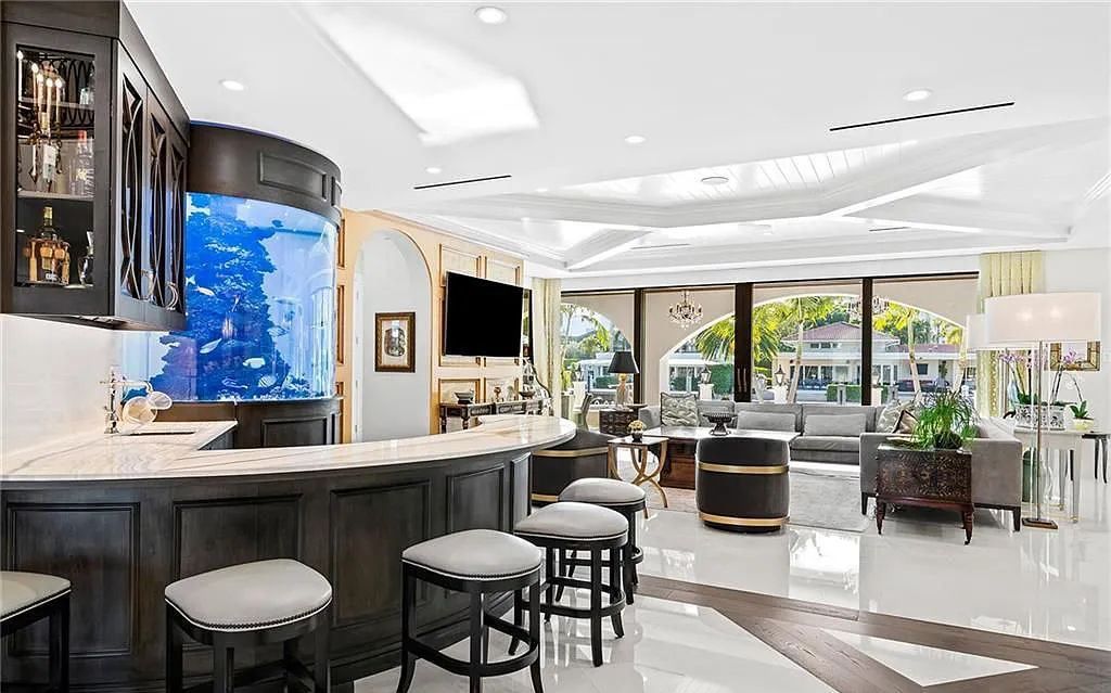 Welcome to 633 Isle of Palms Drive in Fort Lauderdale, Florida, where luxury living meets bespoke grandeur. This custom-built residence features 5 bedrooms, 8 bathrooms, and 7,970 square feet of living space on a 0.30-acre lot with a 100-foot dock, 21K lift, and a resort-like salt pool and spa.