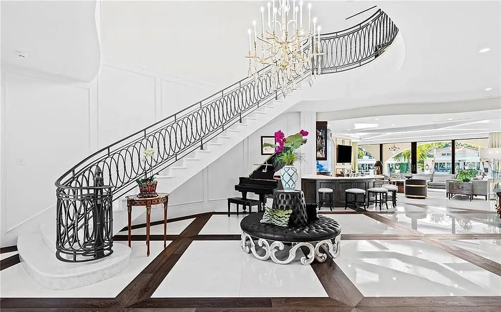 Welcome to 633 Isle of Palms Drive in Fort Lauderdale, Florida, where luxury living meets bespoke grandeur. This custom-built residence features 5 bedrooms, 8 bathrooms, and 7,970 square feet of living space on a 0.30-acre lot with a 100-foot dock, 21K lift, and a resort-like salt pool and spa.