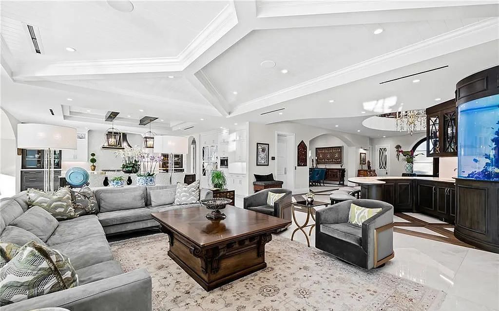 Welcome to 633 Isle of Palms Drive in Fort Lauderdale, Florida, where luxury living meets bespoke grandeur. This custom-built residence features 5 bedrooms, 8 bathrooms, and 7,970 square feet of living space on a 0.30-acre lot with a 100-foot dock, 21K lift, and a resort-like salt pool and spa.