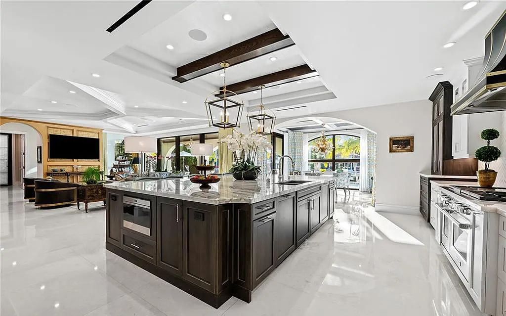 Welcome to 633 Isle of Palms Drive in Fort Lauderdale, Florida, where luxury living meets bespoke grandeur. This custom-built residence features 5 bedrooms, 8 bathrooms, and 7,970 square feet of living space on a 0.30-acre lot with a 100-foot dock, 21K lift, and a resort-like salt pool and spa.