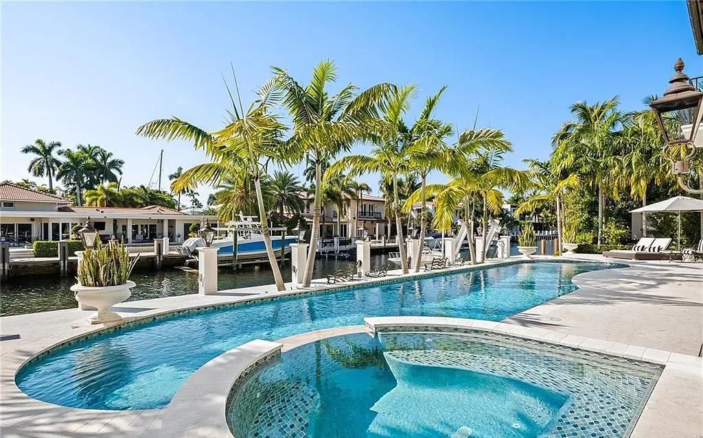 Welcome to 633 Isle of Palms Drive in Fort Lauderdale, Florida, where luxury living meets bespoke grandeur. This custom-built residence features 5 bedrooms, 8 bathrooms, and 7,970 square feet of living space on a 0.30-acre lot with a 100-foot dock, 21K lift, and a resort-like salt pool and spa.