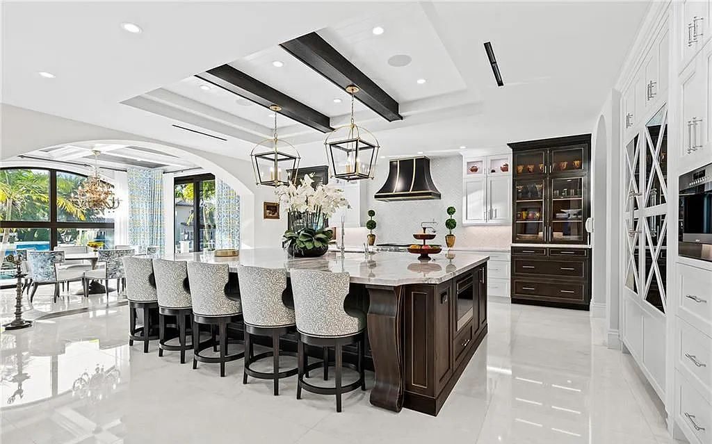 Welcome to 633 Isle of Palms Drive in Fort Lauderdale, Florida, where luxury living meets bespoke grandeur. This custom-built residence features 5 bedrooms, 8 bathrooms, and 7,970 square feet of living space on a 0.30-acre lot with a 100-foot dock, 21K lift, and a resort-like salt pool and spa.