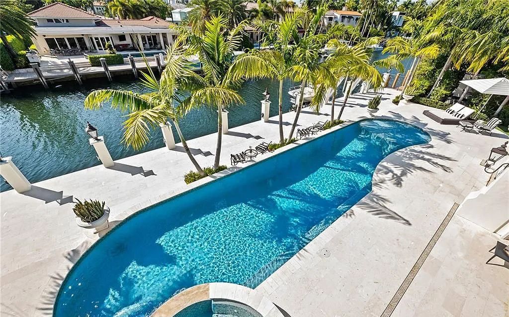Welcome to 633 Isle of Palms Drive in Fort Lauderdale, Florida, where luxury living meets bespoke grandeur. This custom-built residence features 5 bedrooms, 8 bathrooms, and 7,970 square feet of living space on a 0.30-acre lot with a 100-foot dock, 21K lift, and a resort-like salt pool and spa.