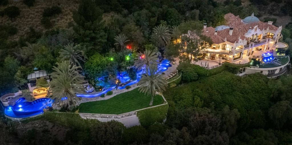 Experience opulent living in Beverly Hills' most desirable zip code with The Cielo Estate. This palatial Andalusian-style masterpiece features 9 bedrooms, 18 bathrooms, 21,000 sq. ft. living space, and 3.60 acres lot size. Enjoy breathtaking city and ocean views, a detached guest house, movie theatre, spa, gym, billiards room, bar, and a 75-yard pool with 3 waterfalls, 2 spas, a 35-foot water slide, and more.
