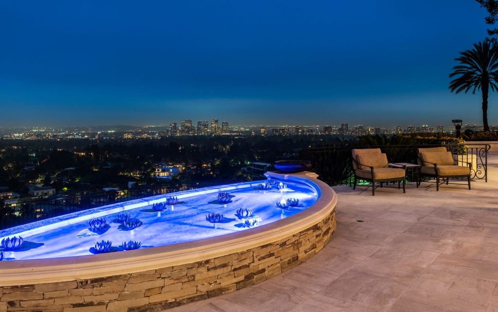 Experience opulent living in Beverly Hills' most desirable zip code with The Cielo Estate. This palatial Andalusian-style masterpiece features 9 bedrooms, 18 bathrooms, 21,000 sq. ft. living space, and 3.60 acres lot size. Enjoy breathtaking city and ocean views, a detached guest house, movie theatre, spa, gym, billiards room, bar, and a 75-yard pool with 3 waterfalls, 2 spas, a 35-foot water slide, and more.