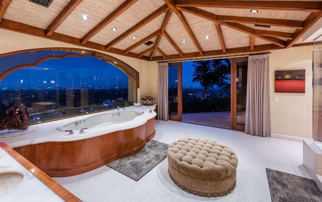 Experience opulent living in Beverly Hills' most desirable zip code with The Cielo Estate. This palatial Andalusian-style masterpiece features 9 bedrooms, 18 bathrooms, 21,000 sq. ft. living space, and 3.60 acres lot size. Enjoy breathtaking city and ocean views, a detached guest house, movie theatre, spa, gym, billiards room, bar, and a 75-yard pool with 3 waterfalls, 2 spas, a 35-foot water slide, and more.