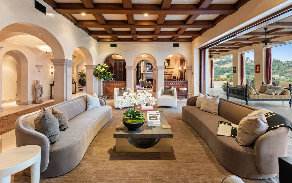 Experience opulent living in Beverly Hills' most desirable zip code with The Cielo Estate. This palatial Andalusian-style masterpiece features 9 bedrooms, 18 bathrooms, 21,000 sq. ft. living space, and 3.60 acres lot size. Enjoy breathtaking city and ocean views, a detached guest house, movie theatre, spa, gym, billiards room, bar, and a 75-yard pool with 3 waterfalls, 2 spas, a 35-foot water slide, and more.