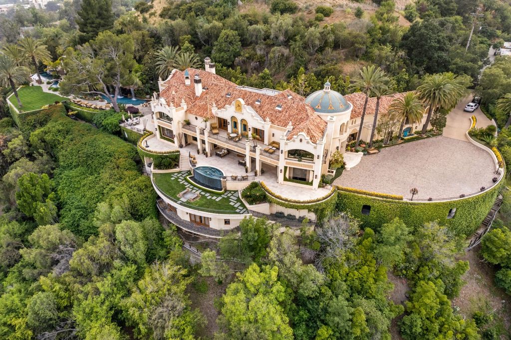 Experience opulent living in Beverly Hills' most desirable zip code with The Cielo Estate. This palatial Andalusian-style masterpiece features 9 bedrooms, 18 bathrooms, 21,000 sq. ft. living space, and 3.60 acres lot size. Enjoy breathtaking city and ocean views, a detached guest house, movie theatre, spa, gym, billiards room, bar, and a 75-yard pool with 3 waterfalls, 2 spas, a 35-foot water slide, and more.