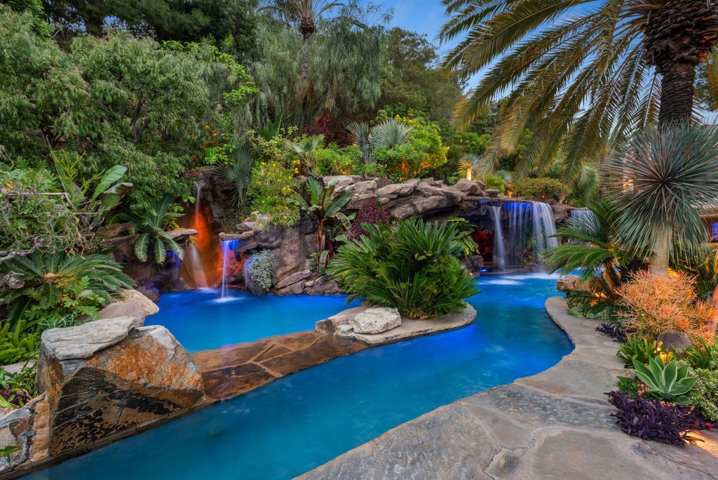 Experience opulent living in Beverly Hills' most desirable zip code with The Cielo Estate. This palatial Andalusian-style masterpiece features 9 bedrooms, 18 bathrooms, 21,000 sq. ft. living space, and 3.60 acres lot size. Enjoy breathtaking city and ocean views, a detached guest house, movie theatre, spa, gym, billiards room, bar, and a 75-yard pool with 3 waterfalls, 2 spas, a 35-foot water slide, and more.