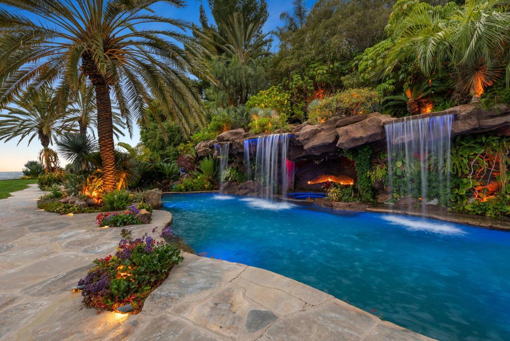 Experience opulent living in Beverly Hills' most desirable zip code with The Cielo Estate. This palatial Andalusian-style masterpiece features 9 bedrooms, 18 bathrooms, 21,000 sq. ft. living space, and 3.60 acres lot size. Enjoy breathtaking city and ocean views, a detached guest house, movie theatre, spa, gym, billiards room, bar, and a 75-yard pool with 3 waterfalls, 2 spas, a 35-foot water slide, and more.