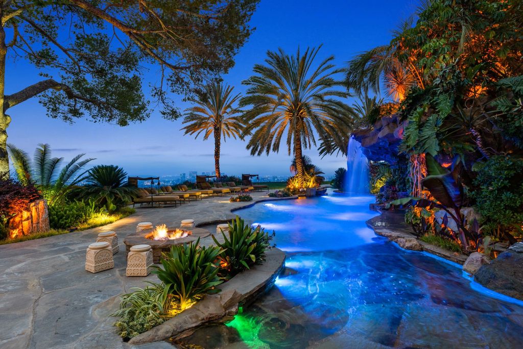 Experience opulent living in Beverly Hills' most desirable zip code with The Cielo Estate. This palatial Andalusian-style masterpiece features 9 bedrooms, 18 bathrooms, 21,000 sq. ft. living space, and 3.60 acres lot size. Enjoy breathtaking city and ocean views, a detached guest house, movie theatre, spa, gym, billiards room, bar, and a 75-yard pool with 3 waterfalls, 2 spas, a 35-foot water slide, and more.