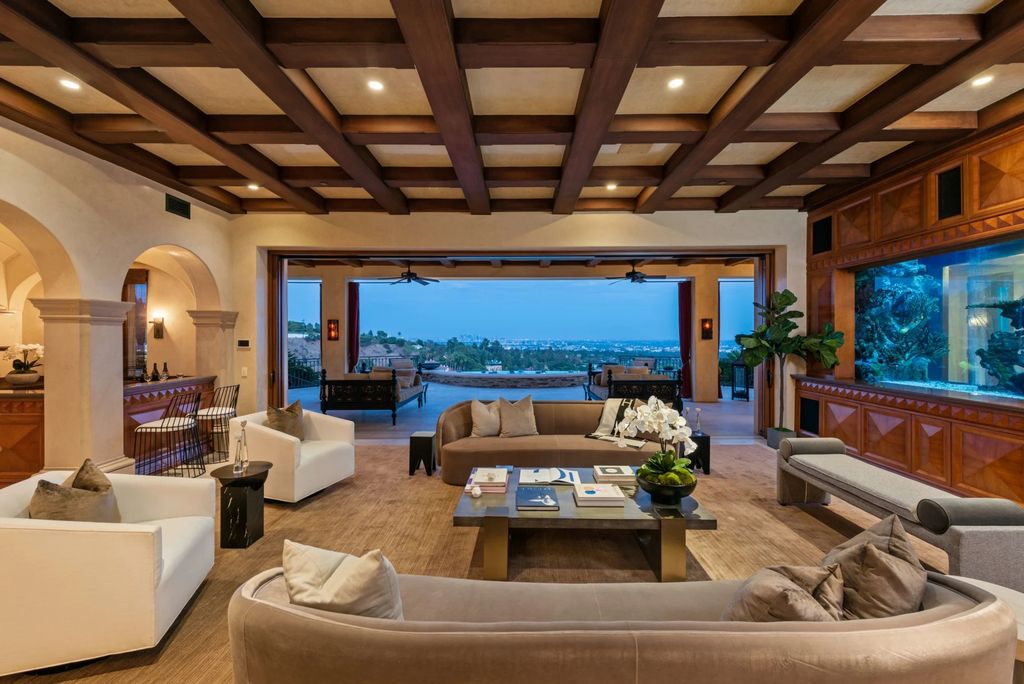 Experience opulent living in Beverly Hills' most desirable zip code with The Cielo Estate. This palatial Andalusian-style masterpiece features 9 bedrooms, 18 bathrooms, 21,000 sq. ft. living space, and 3.60 acres lot size. Enjoy breathtaking city and ocean views, a detached guest house, movie theatre, spa, gym, billiards room, bar, and a 75-yard pool with 3 waterfalls, 2 spas, a 35-foot water slide, and more.