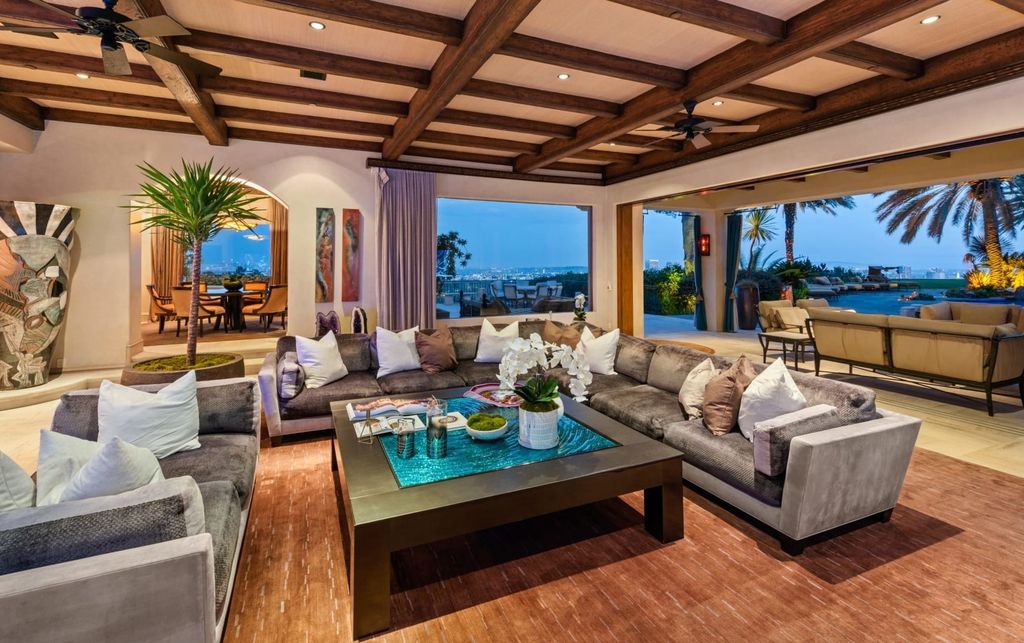 Experience opulent living in Beverly Hills' most desirable zip code with The Cielo Estate. This palatial Andalusian-style masterpiece features 9 bedrooms, 18 bathrooms, 21,000 sq. ft. living space, and 3.60 acres lot size. Enjoy breathtaking city and ocean views, a detached guest house, movie theatre, spa, gym, billiards room, bar, and a 75-yard pool with 3 waterfalls, 2 spas, a 35-foot water slide, and more.