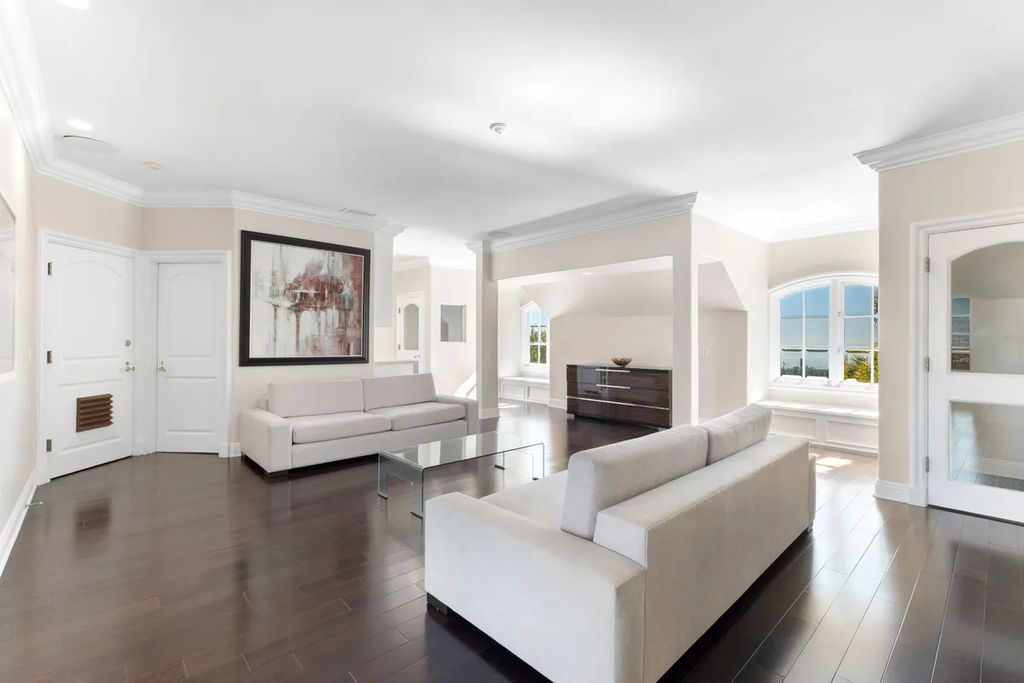 This exquisite estate offers breathtaking 360-degree views of the ocean sunsets, city lights, and Santa Monica mountains skyline, visible from its three stunning balconies. With over 9,300 square feet of space, this luxurious property boasts five bedrooms, seven bathrooms, three living rooms, formal and informal dining areas, and five beautiful fireplaces. The grand entrance through double doors leads to a dramatic 2-story foyer with 30-foot windows that flood the space with natural light, and limestone floors create an elegant touch.